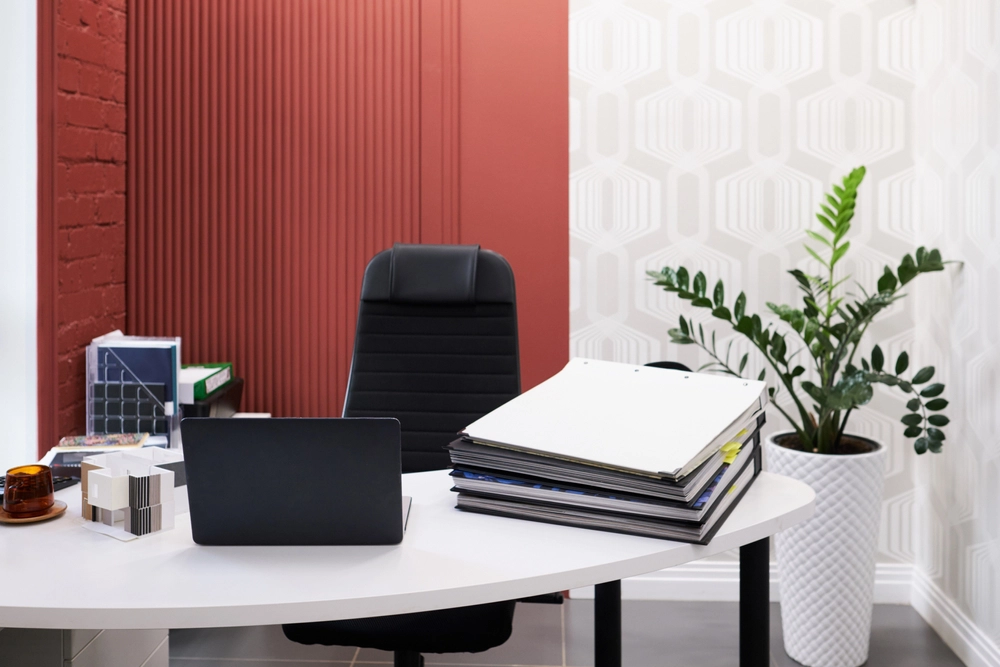 Office design trends 2023 | Brick-walled office with plants and modern furniture. 