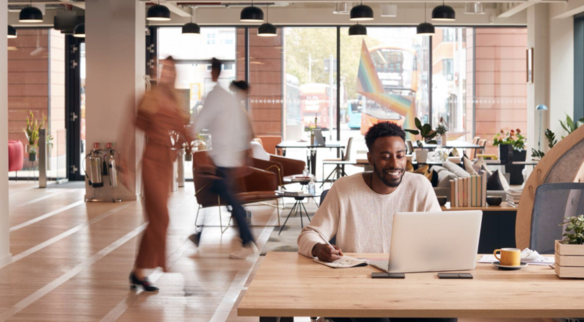 Office life | Person sitting at a desk in a busy office